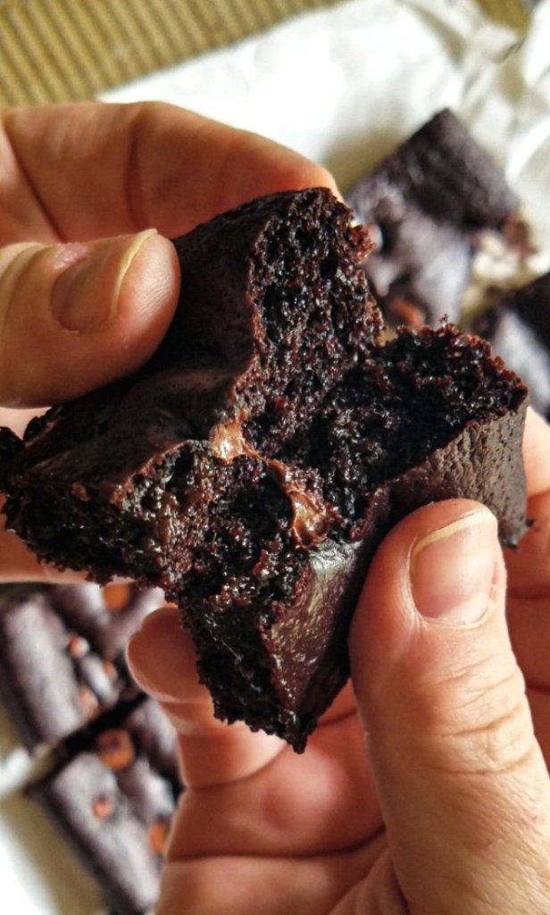 fudgy brownie broken in half to reveal the moist center