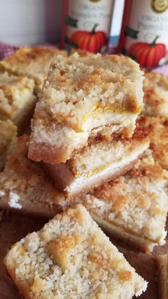 pumpkin cheesecake bars with pumpkin cans in background