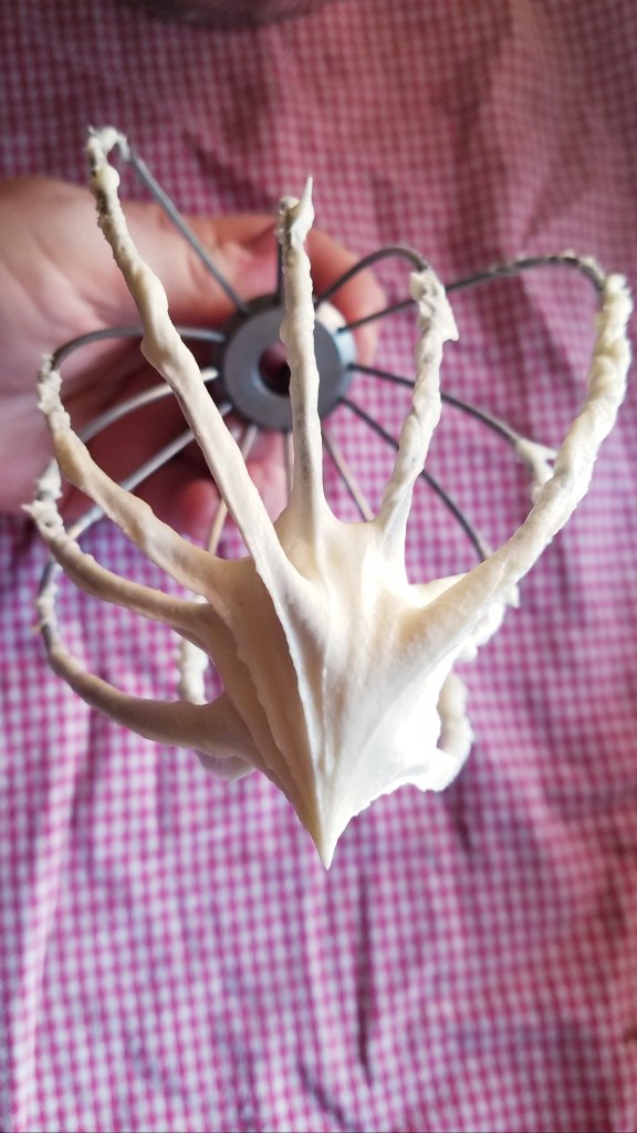 gluten free buttercream frosting on a whisk.