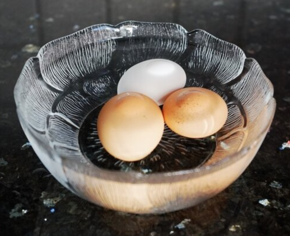 eggs warming in a bowl of warm water.