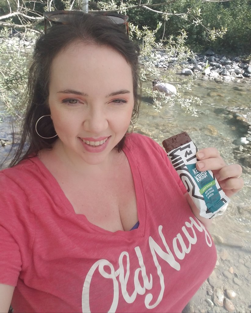 Melissa enjoying a Keto Krisp bar at the river