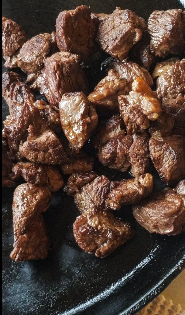 browned bear stew meat on a plate to the side