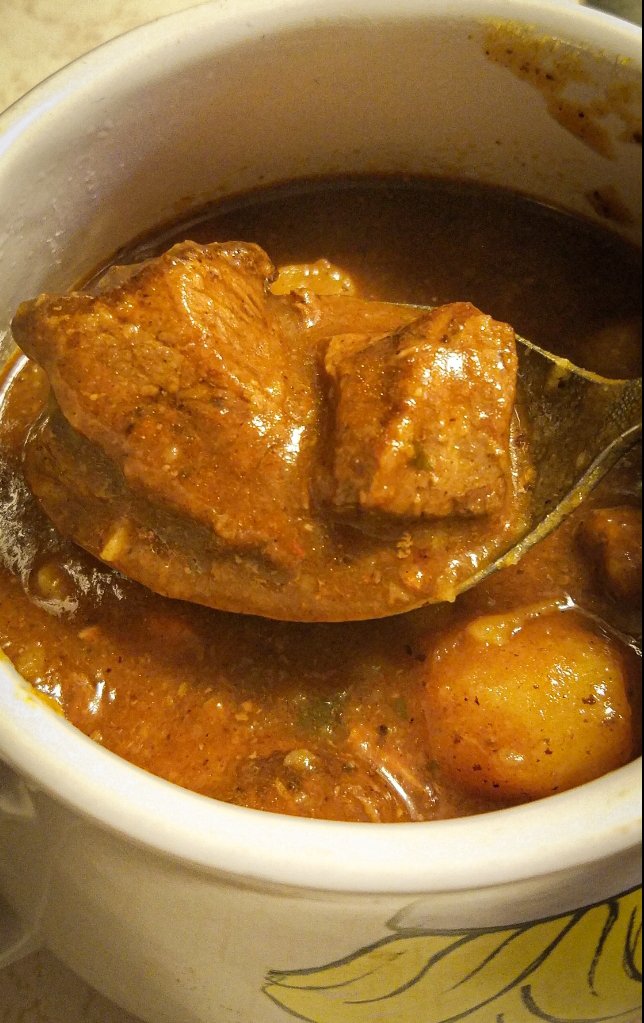 bear stew on a spoon in a mug