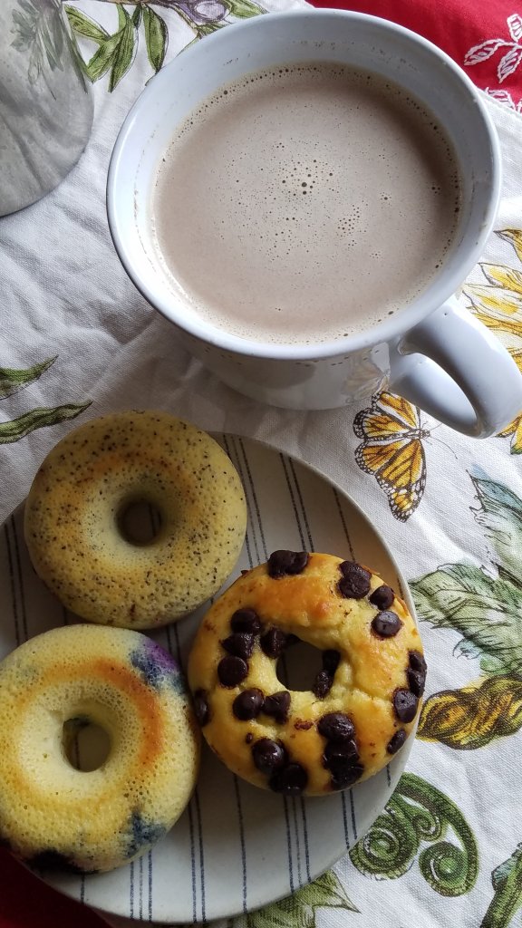 cup of coffee with three different flavors of my easy keto bagels with coconut flour
