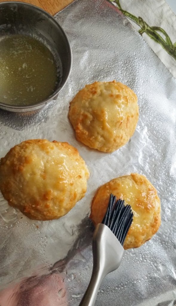 brushing butter on the biscuits