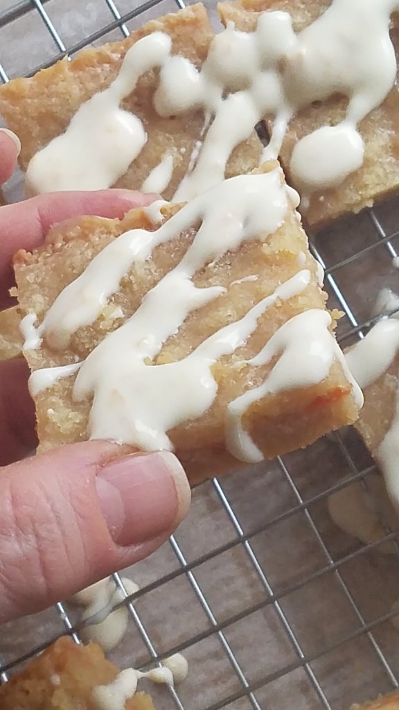 low carb marmalade crumble bars with drizzle topping cut into squares.