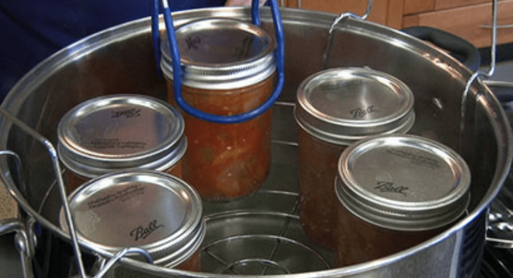 lifting out processed jars of Sugar Free Grapefruit Marmalade