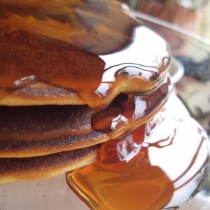 Keto maple syrup dripping off of a stack of pancakes.