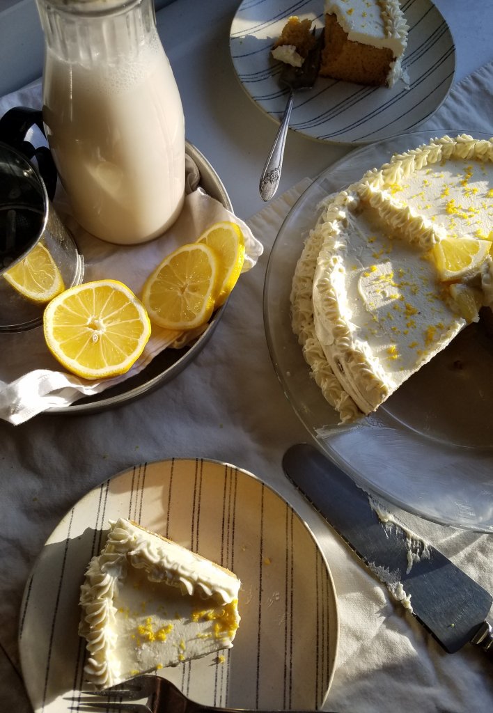  the best sugar free lemon cake served up on a plate with milk nearby