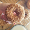 Gluten Free Coconut Crunch Donuts after glazing and coating with toasted coconut.