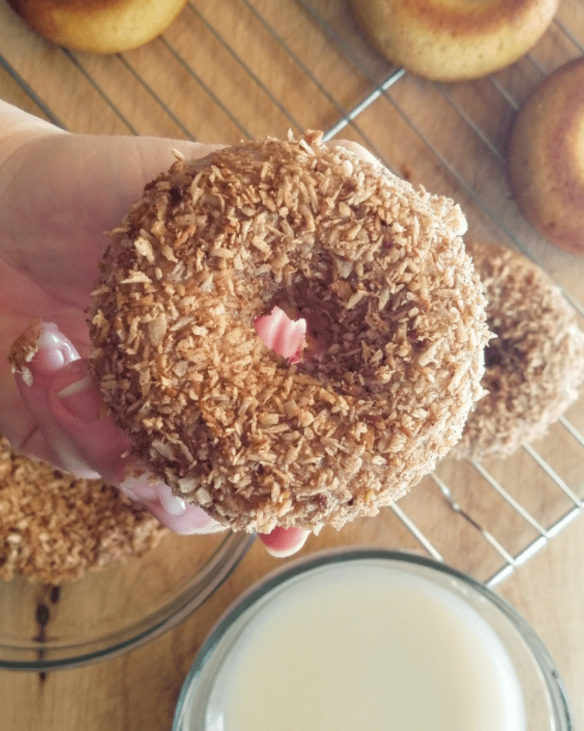 Gluten Free Coconut Crunch Donuts after glazing and coating with toasted coconut.