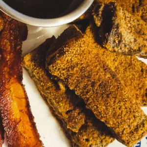 keto french toast sticks with maple dipping sauce in a small silver bowl