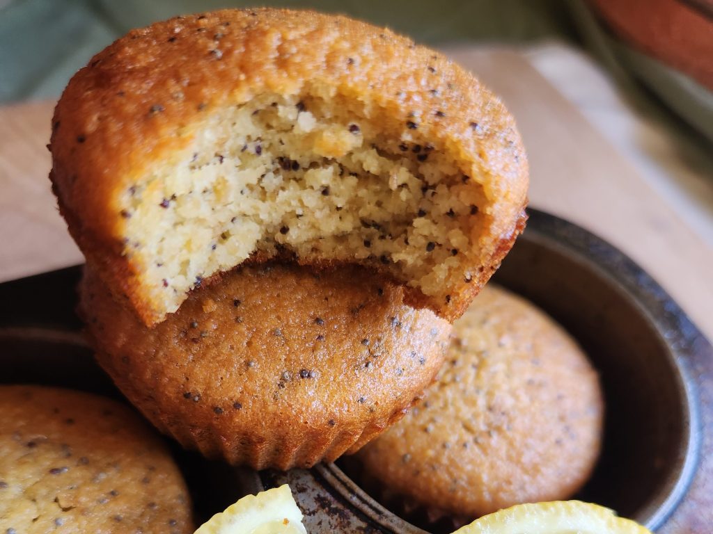 Small stack of lemon poppyseed muffins in muffin tin