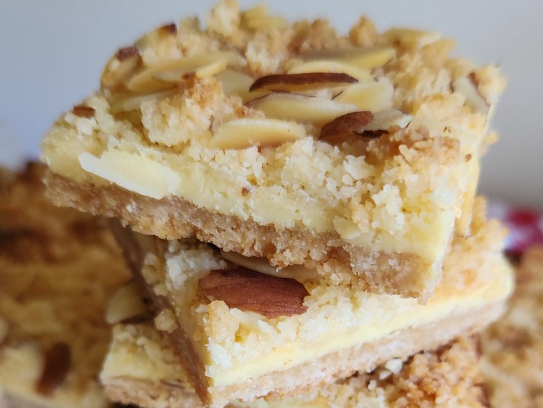 easy almond cheesecake bars stacked up