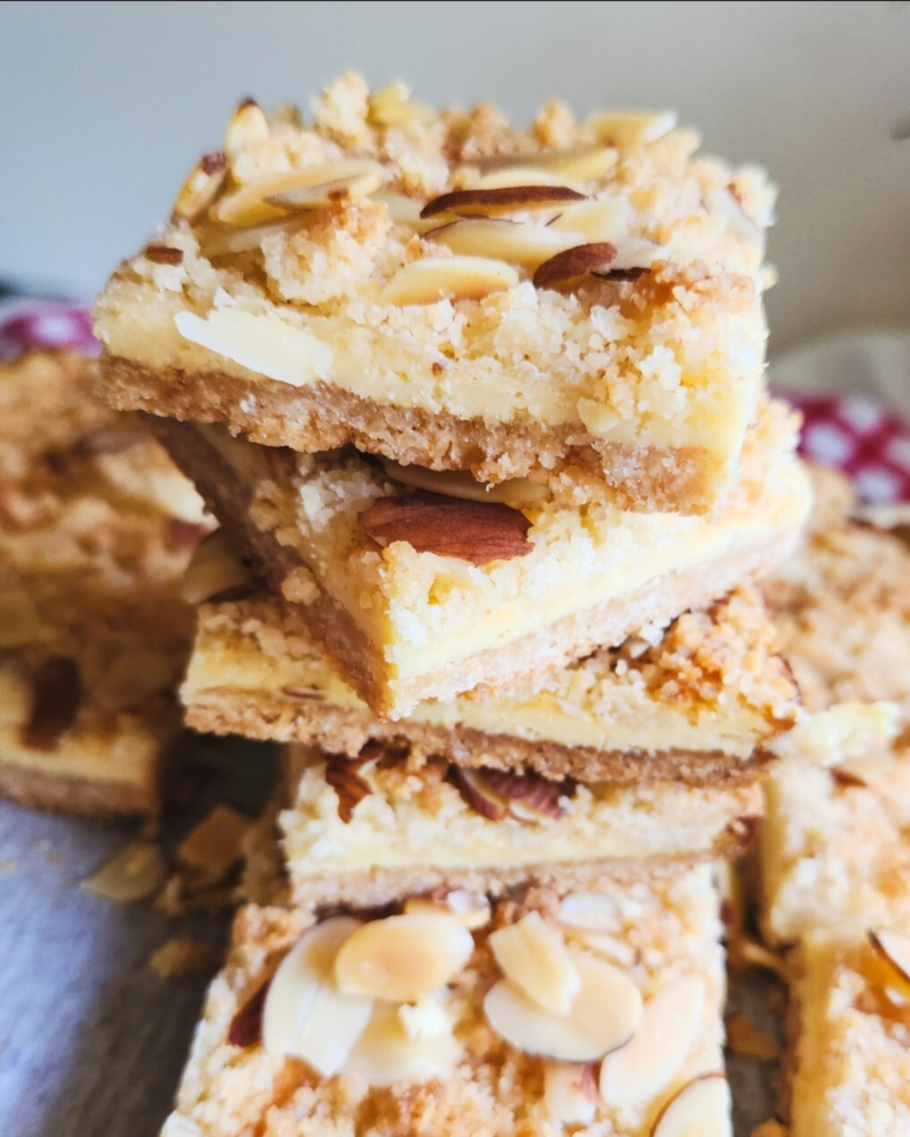 easy low carb almond cheesecake bars stacked in a tower