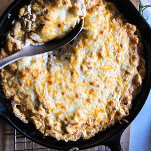 gluten free cheesy green chile chicken skillet with a spoon serving it up