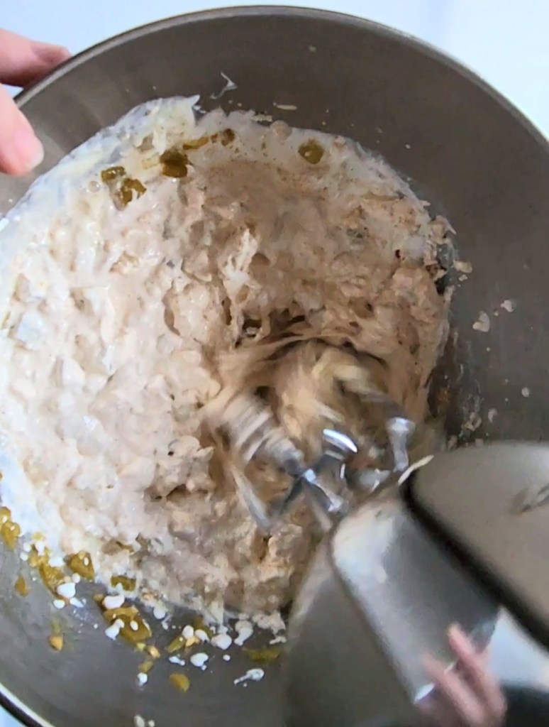 mixing up the cream cheese mixture with a hand mixer