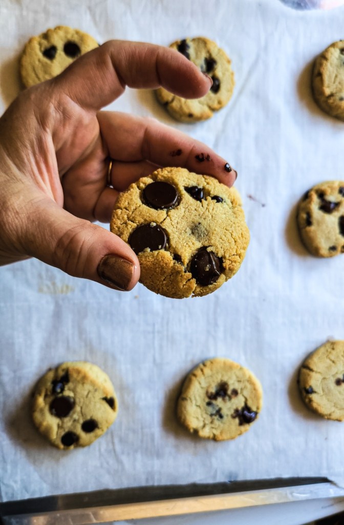holding one of the gluten free butterless chocolate chip cookies baked.