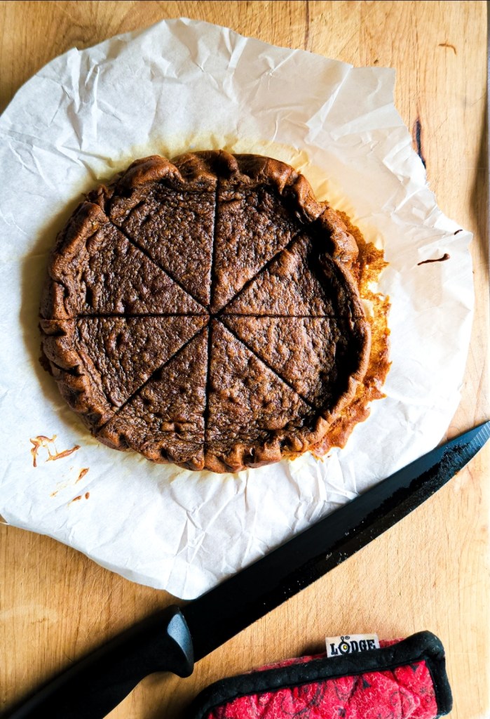 A piece of Gluten-free dairy free cinnamon bread being shown on parchment paper