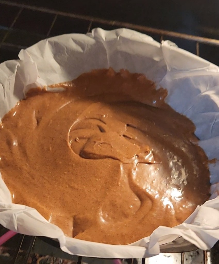 Gluten-free dairy free cinnamon bread batter in skillet going into oven