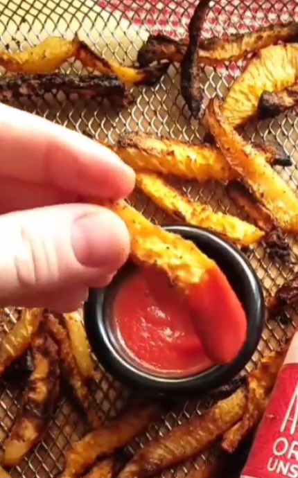 Kohlrabi Sticks being dipped in ketchup