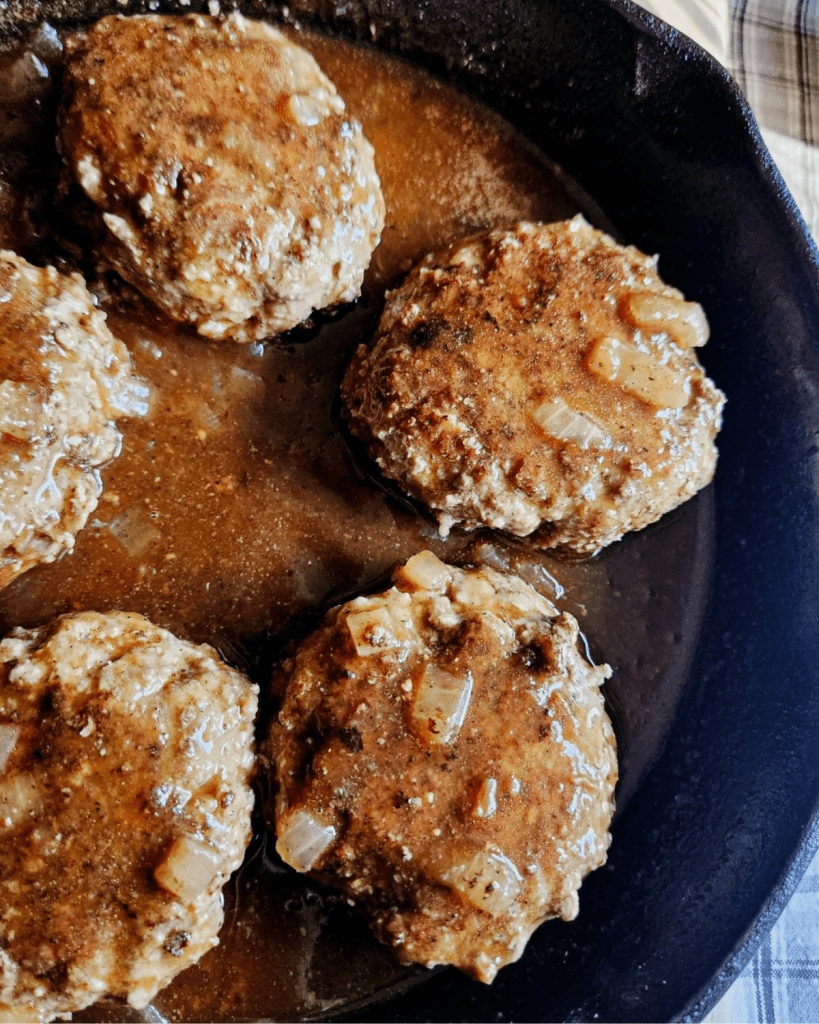Gluten free Salisbury steak finished in a cast iron pan