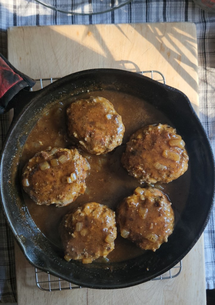 Gluten free Salisbury steak patties prepared with brown gravy