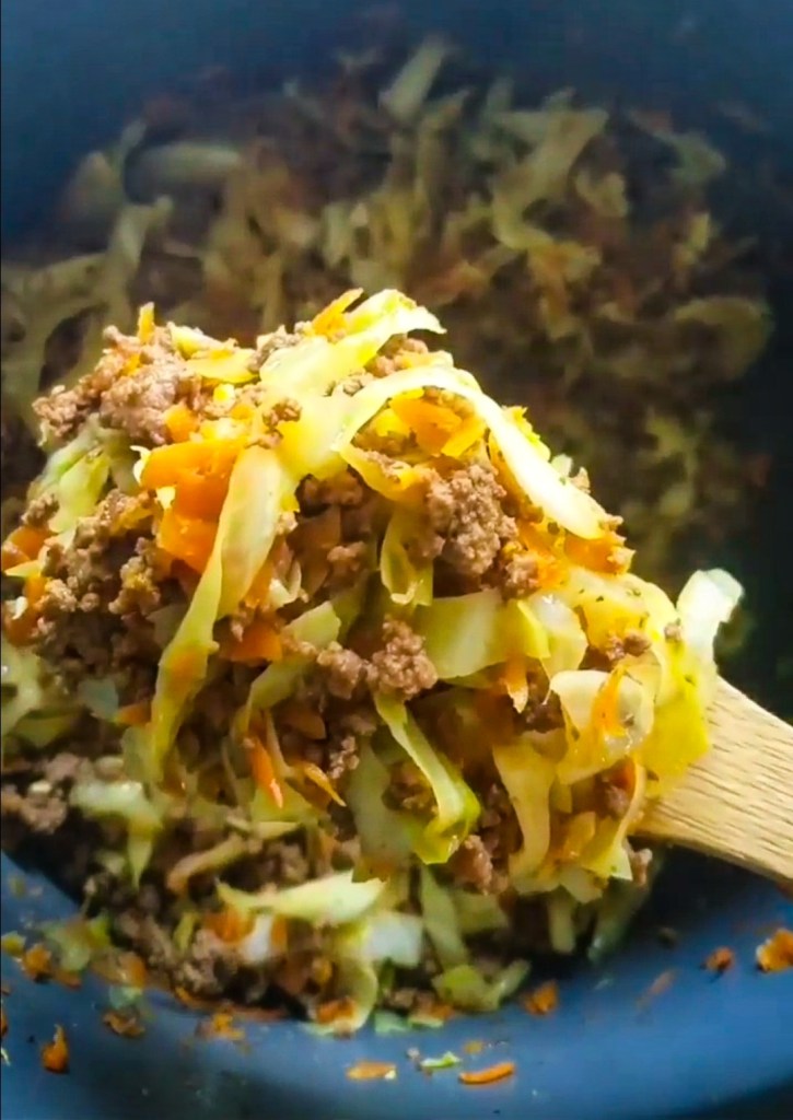 Finished instant pot low carb Egg Roll in a bowl being served up with a spoon