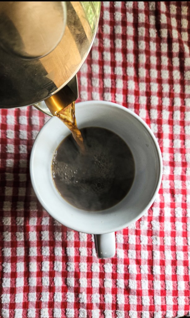 pouring coffee into a cup.