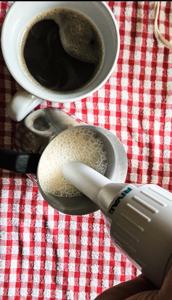 frothing milk with an immersion blender.