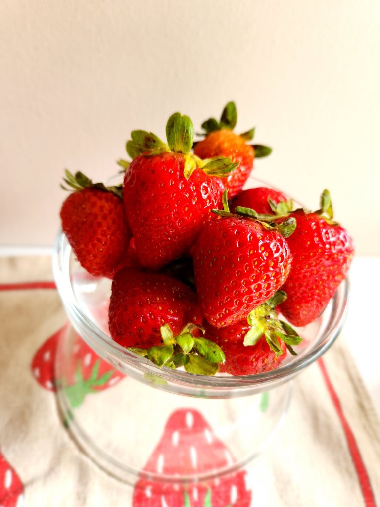 fresh strawberries in a glass bowl.