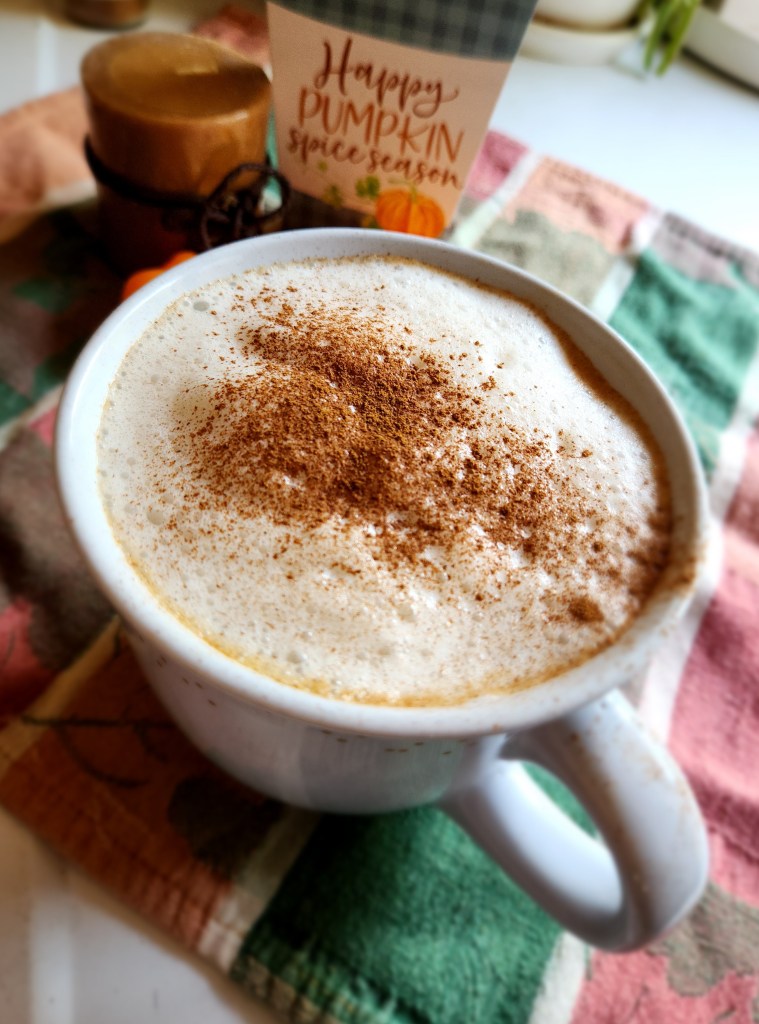 Gluten Free Starbucks Pumpkin Spice Latte in a mug with spice sprinkled on the foam