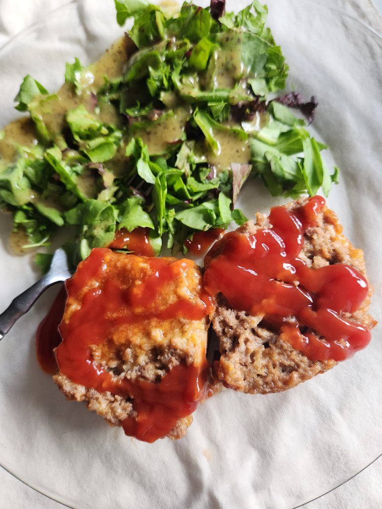 Easy keto ground beef instapot meatloaf served up with salad and a drizzle of ketchup