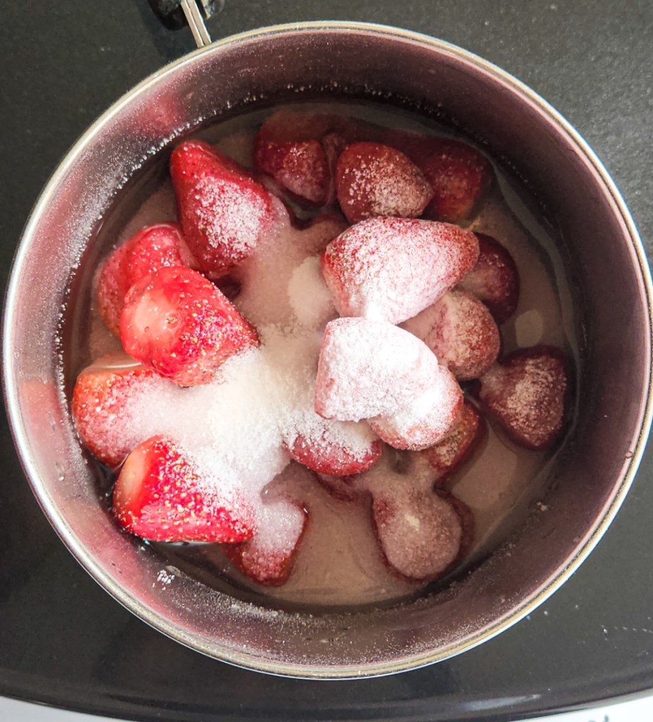 strawberries in a saucepan to make sauce with sweetener.