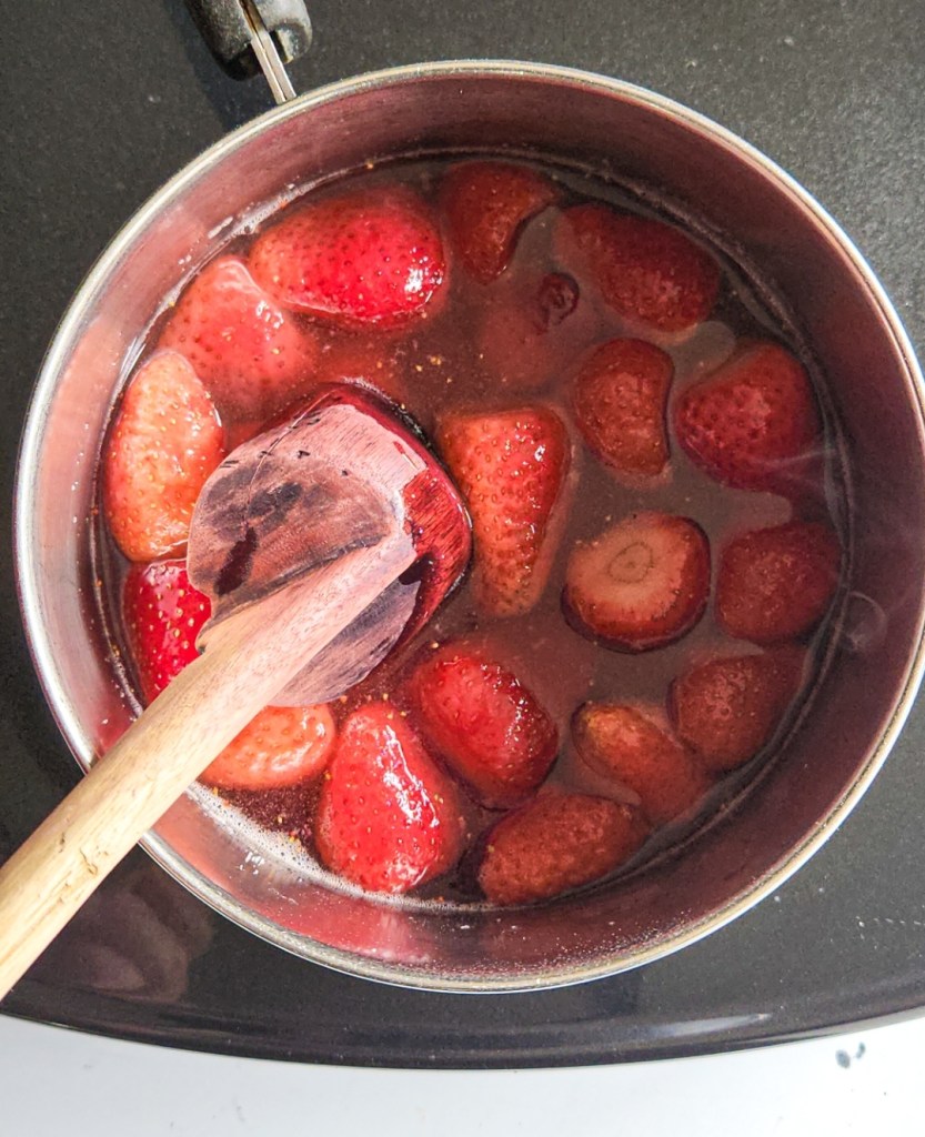 strawberries in a saucepan to make sauce.