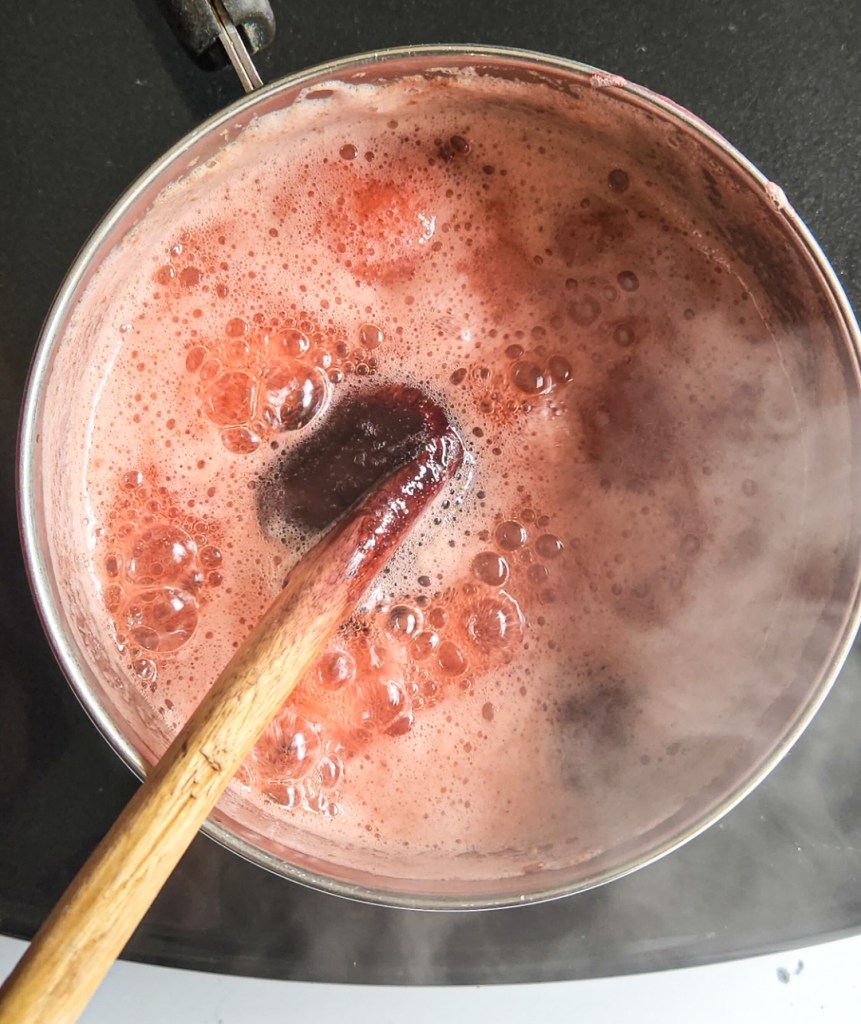 strawberries in a saucepan to make sauce boiling.