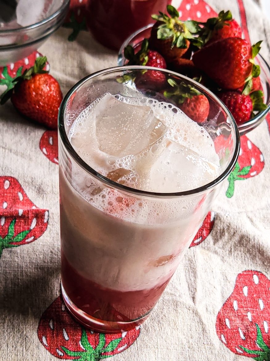 ice with glass and strawberry syrup and unsweetneed almond milk.