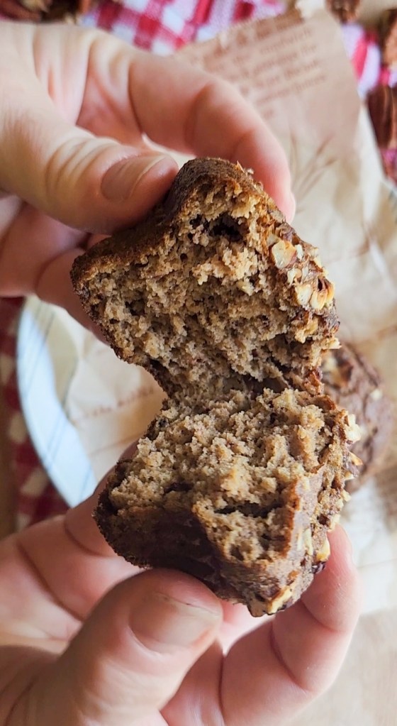 a dairy free gluten free pecan muffin broken in two pieces.