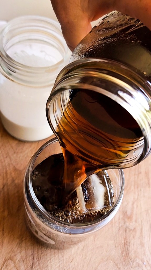 Pouring coffee over ice.