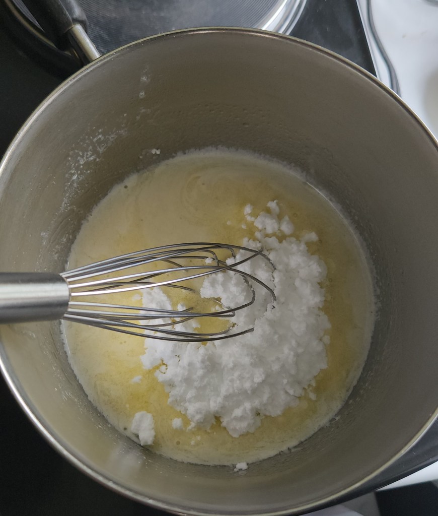 melted butter being mixed with confectioners erythritol.