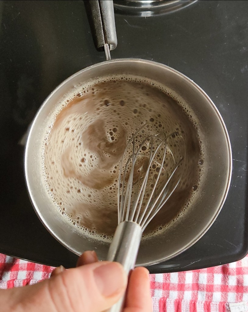 Easy keto maple syrup substitute recipe being whisked in a pan.