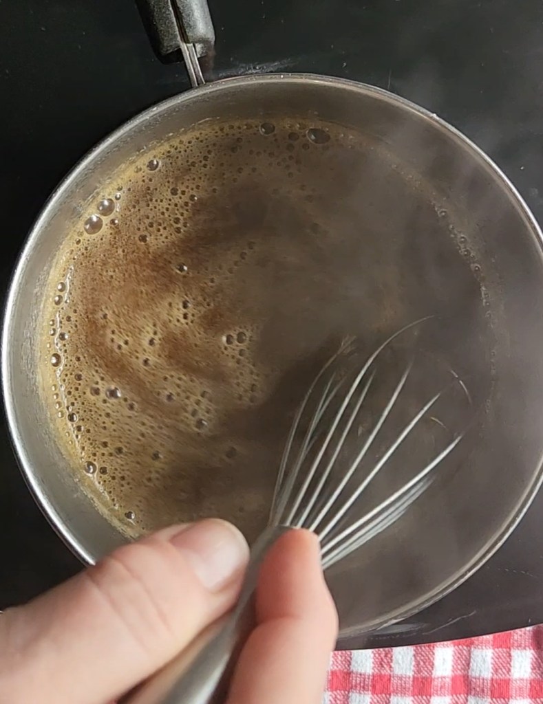 Easy keto maple syrup substitute recipe simmering in a saucepan.