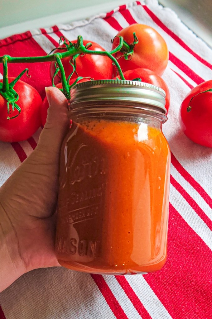 Easy low carb recipe for enchilada sauce put into a quart jar with lid ready for freezing.