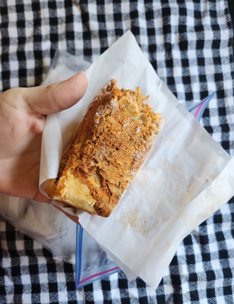 low carb mexican casserole frozen in squares and wrapped in parchment paper.