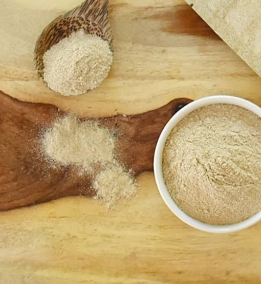 psyllium husk powder in a bowl and some on a spoon.