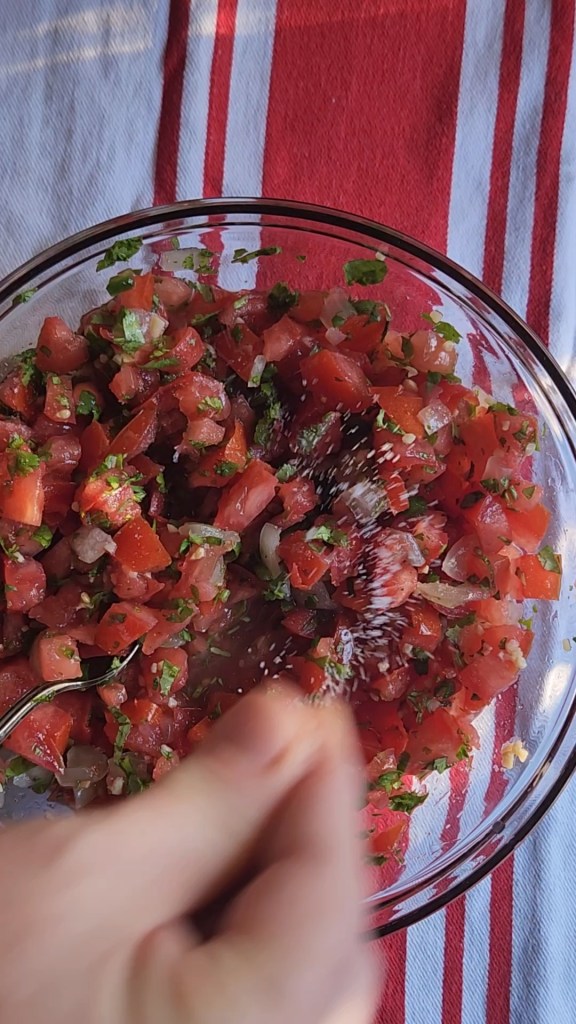 sprinkling salt and pepper all over the fresh pico de gallo.