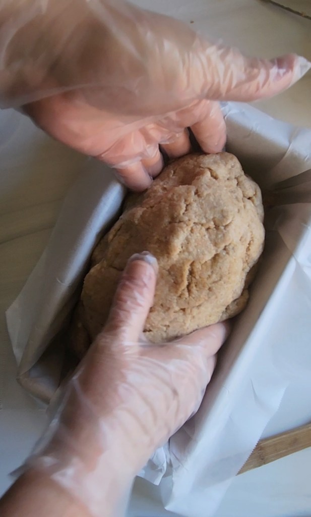 placing the formed dough into the prepared bread pan.