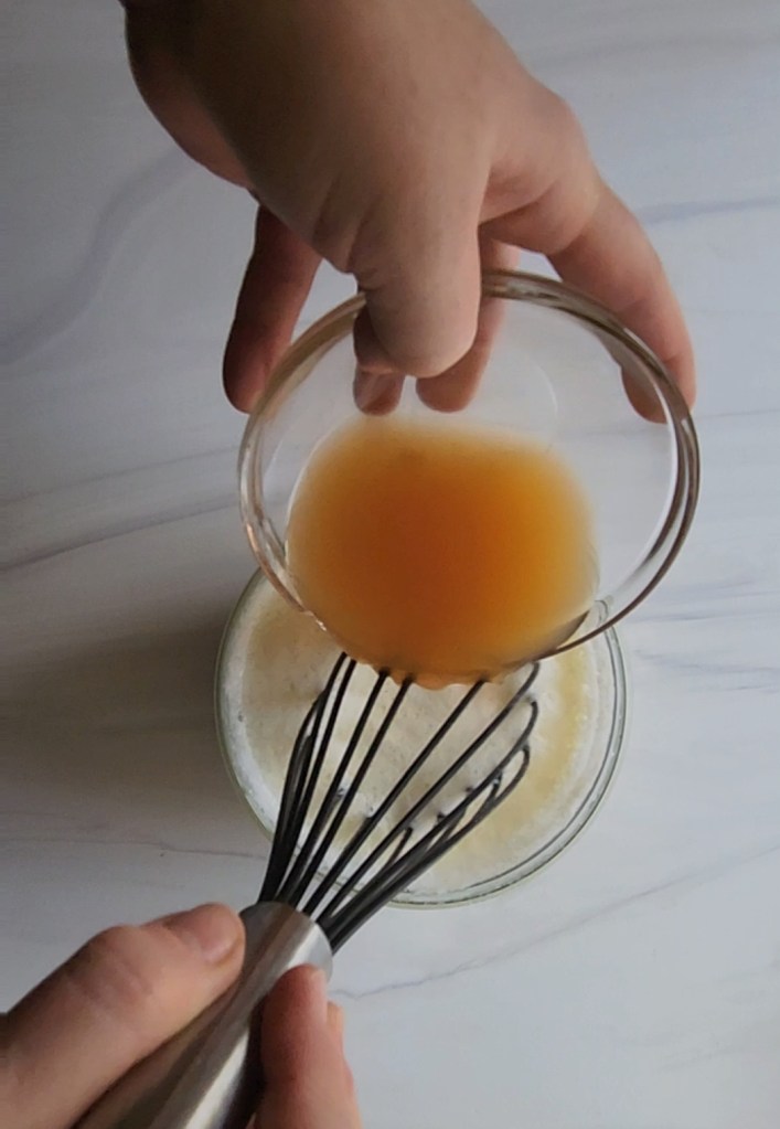 adding apple cider vinegar to the frothed egg whites.