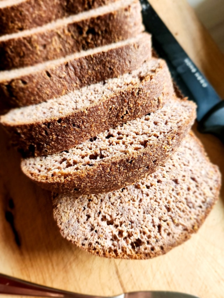 The best gluten-free low-carb bread recipe cut into slices on a cutting board.