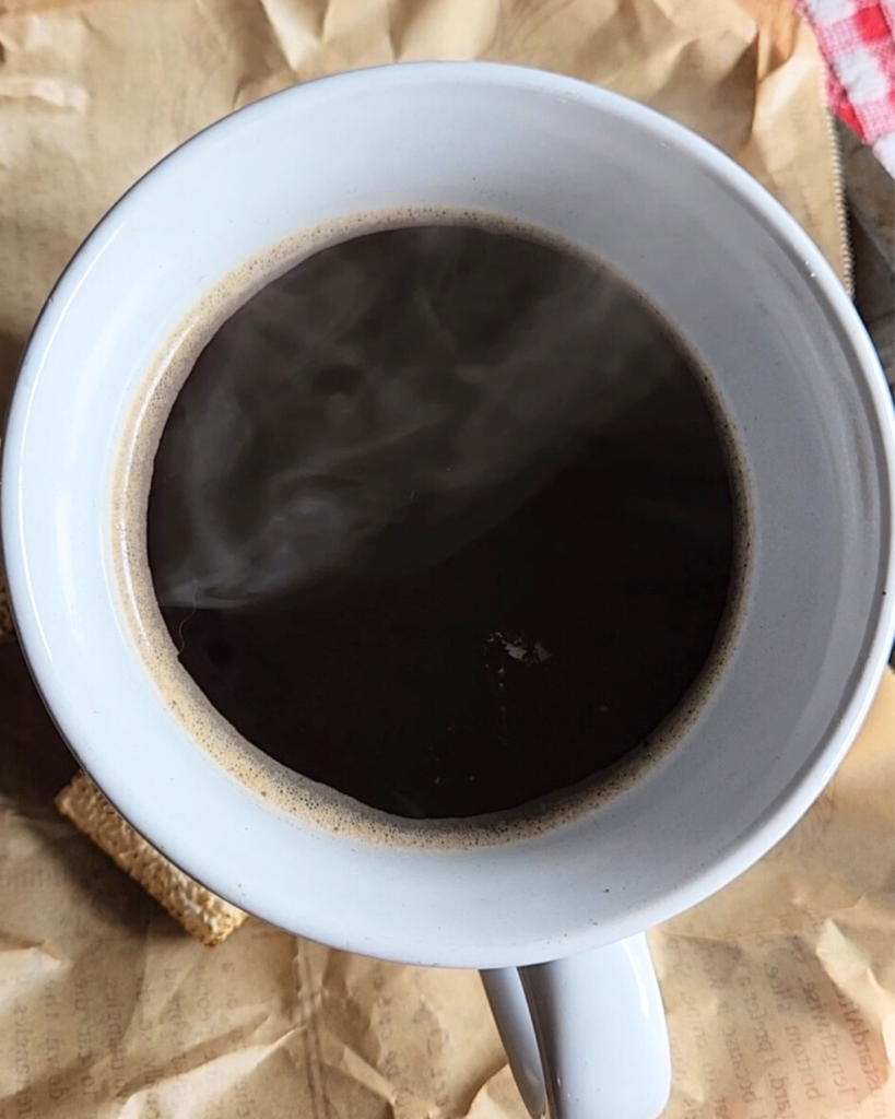 Black coffee and a large white coffee mug.